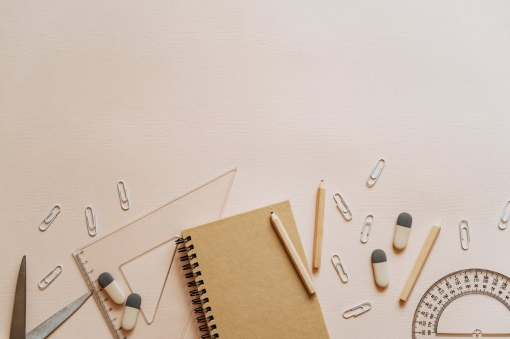 Spiral Notebook Pencils and Paper Clips Flatlay